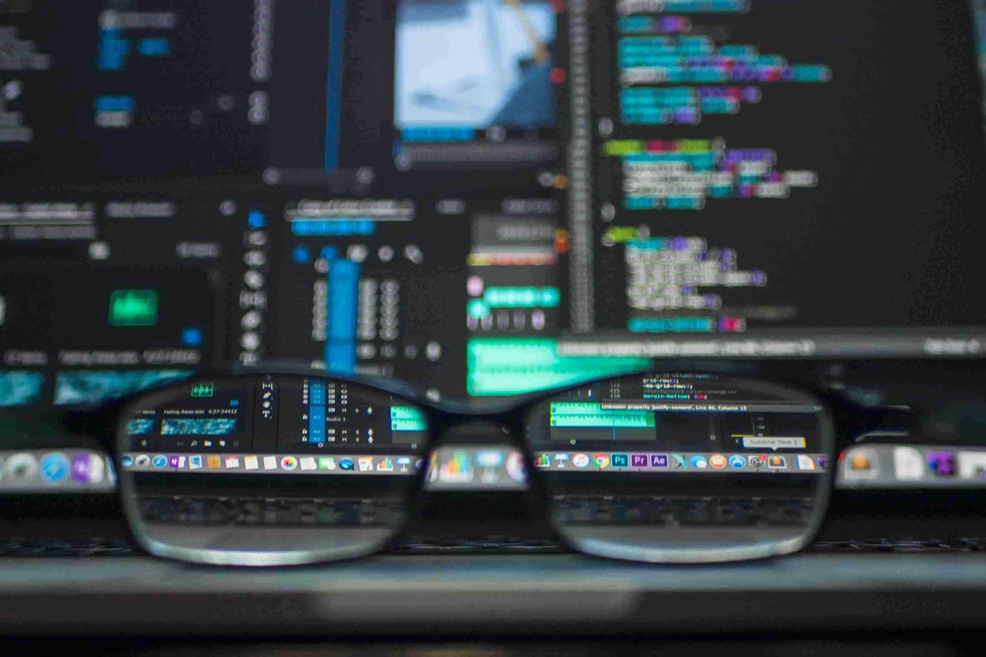Eyeglasses in front of computer screens